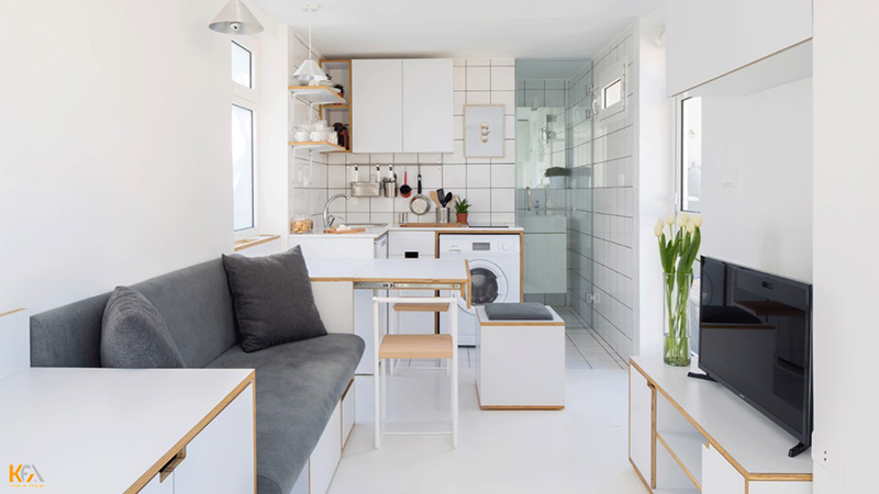 Thiết kế phòng khách liền phòng bếp với không gian gọn gàng sạch sẽ cùng tone màu trắng nổi bật